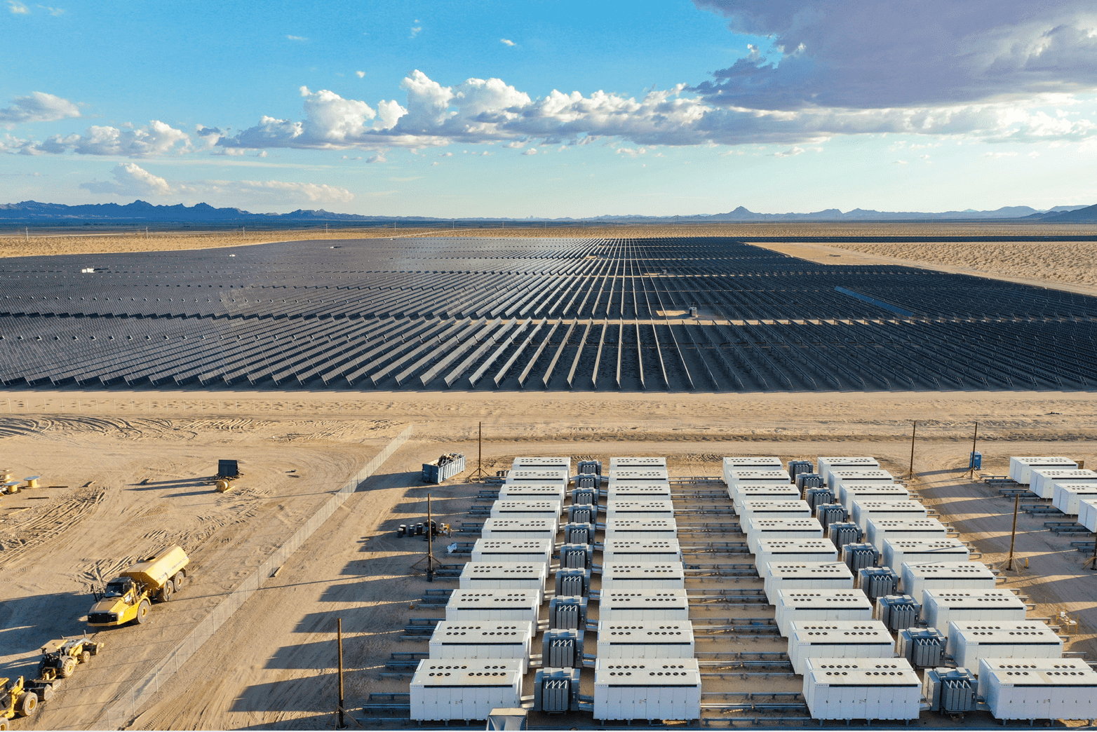 View of a solar field with control modules in the foreground